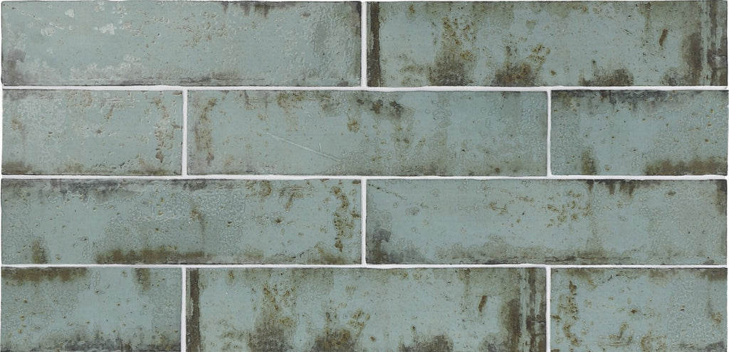 Closeup of aqua distressed ceramic subway tile backsplash