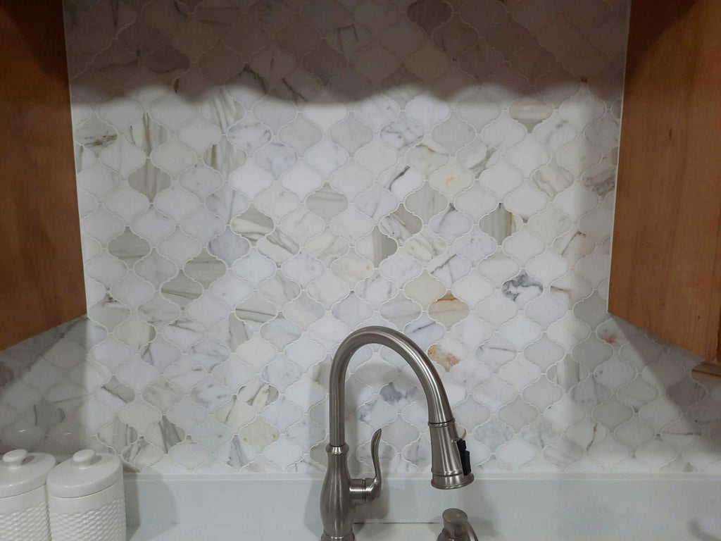 Closeup of Calacatta Marble Arabesque Lantern Tile Backsplash Behind Kitchen Sink